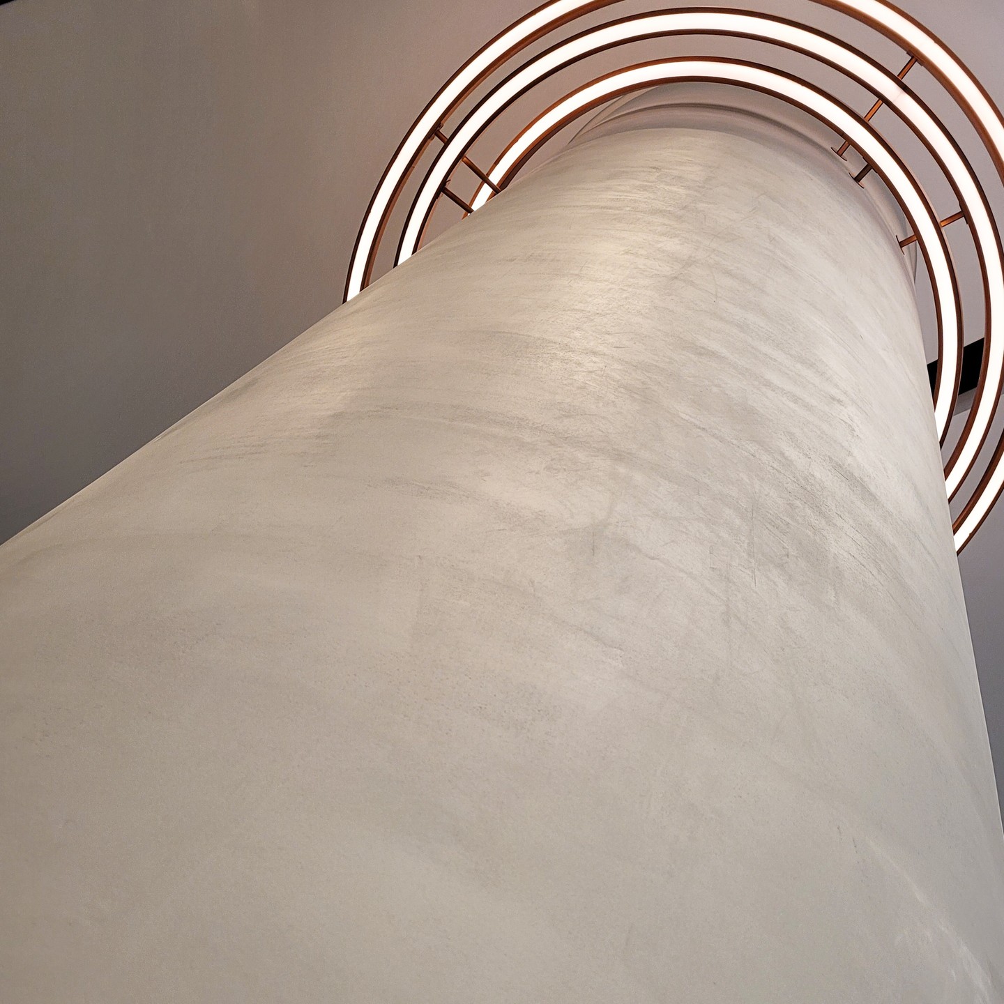 Curved architectural column finished with hand-applied microtopping